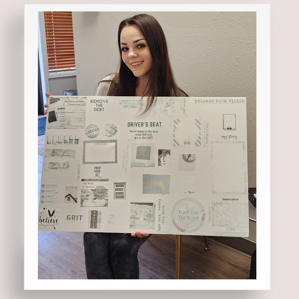 vision board customer holding her white graphics and images vision board up